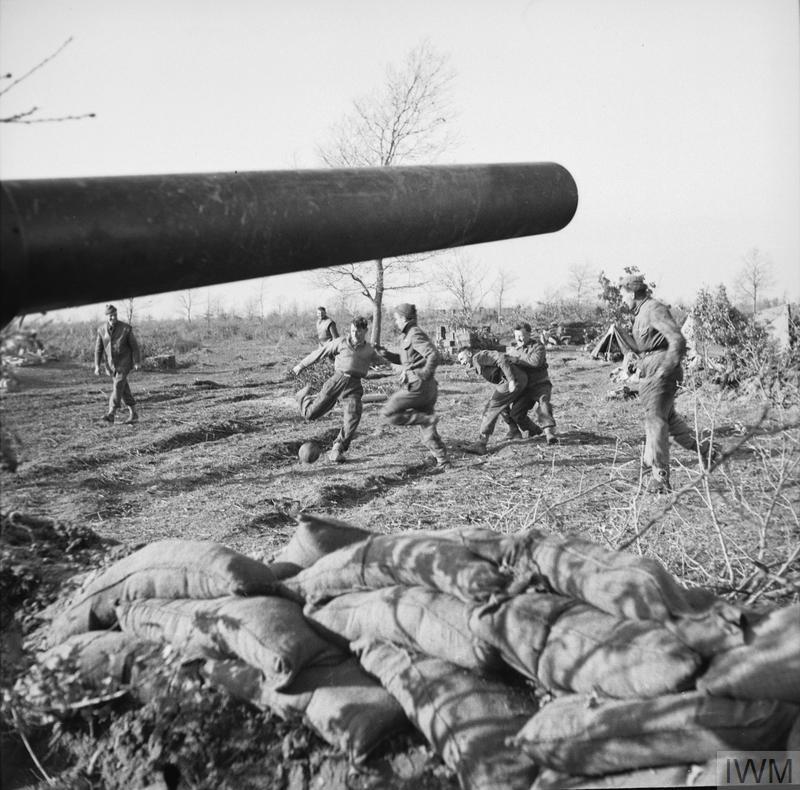 Gunners of 111 Medium Battery, 80th (Scottish Horse) Medium Regiment, Royal Artillery, playing a game of football near their guns in the Anzio area, Italy.