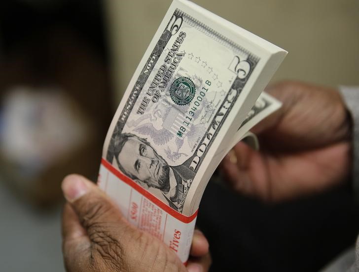 Dollar edges lower as risk sentiment improves