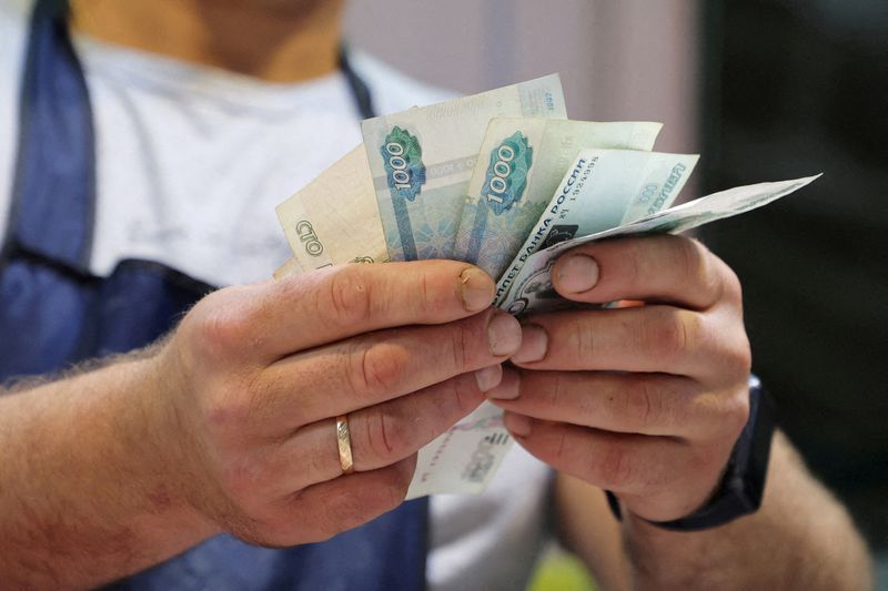 Volatile rouble firms past 95 vs dollar amid capital controls speculation